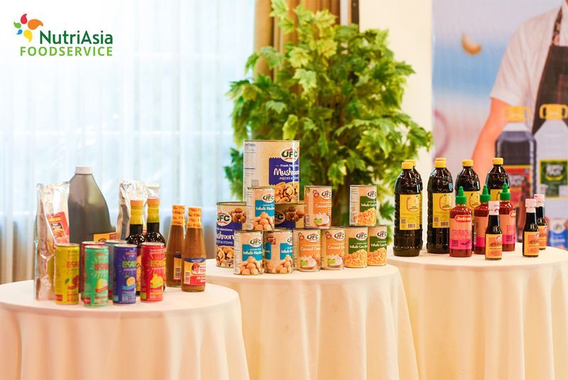 NutriAsia Foodservice product display on a table with plants