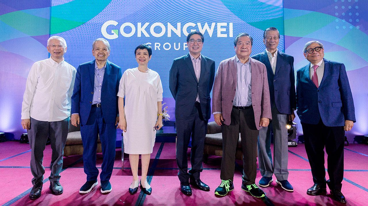 Gokongwei Group executives posing together on stage at an event