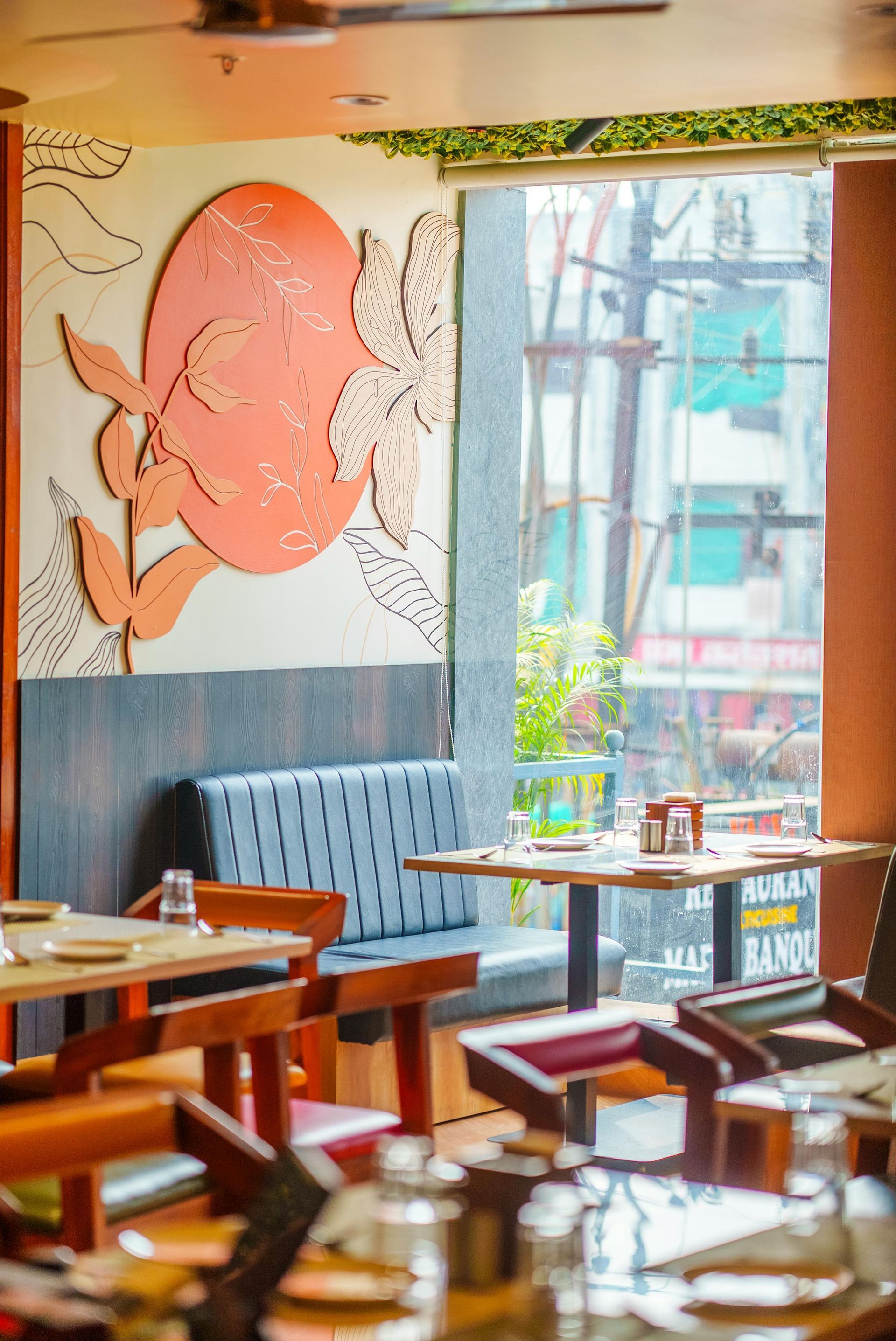 Cozy restaurant booth with blue seating and a koi wall mural
