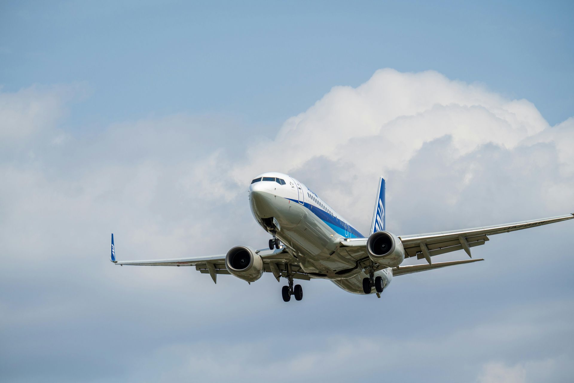 Commercial airplane in flight against a cloudy sky