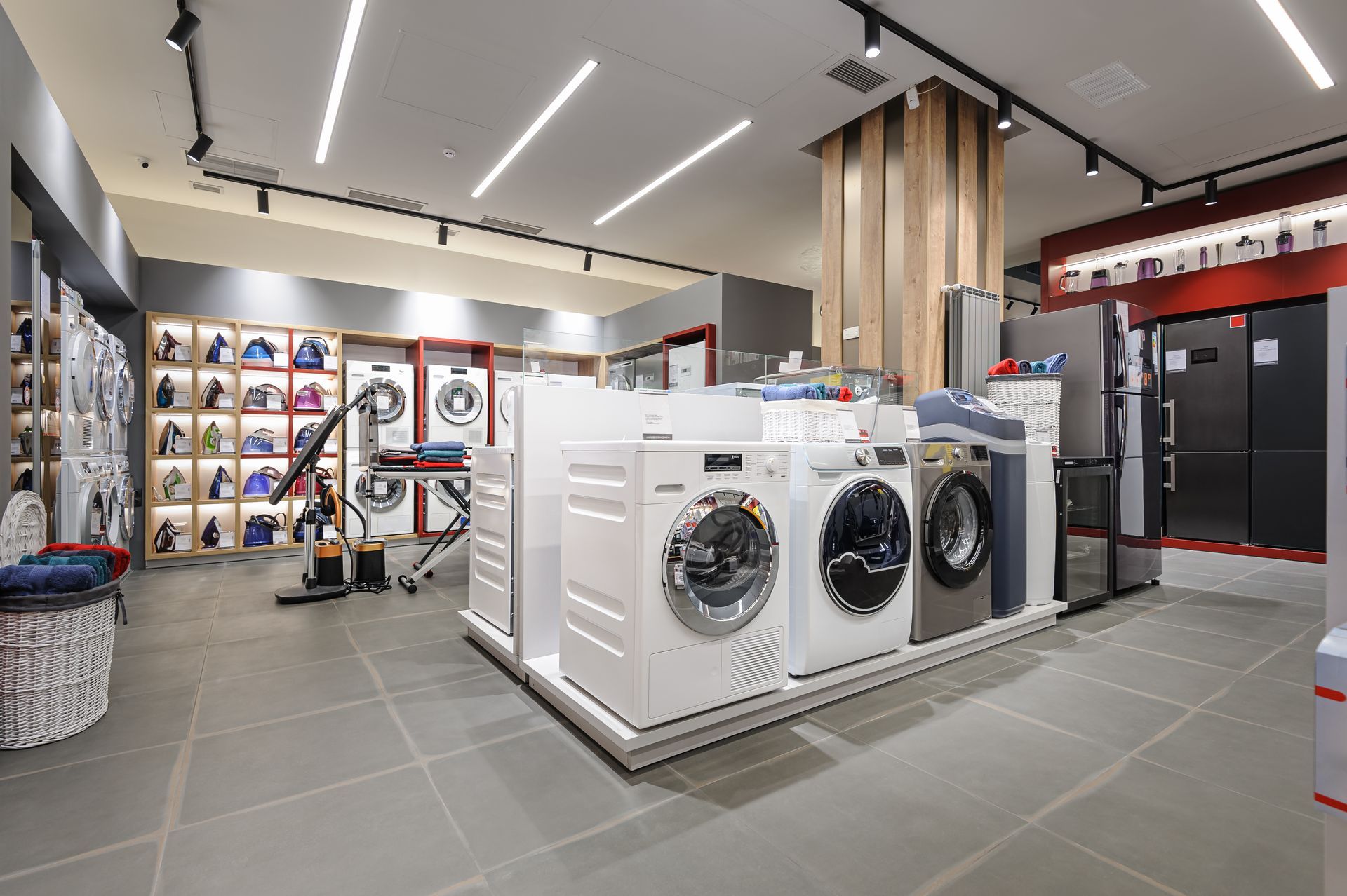 Showroom floor displaying washing machines and home appliances