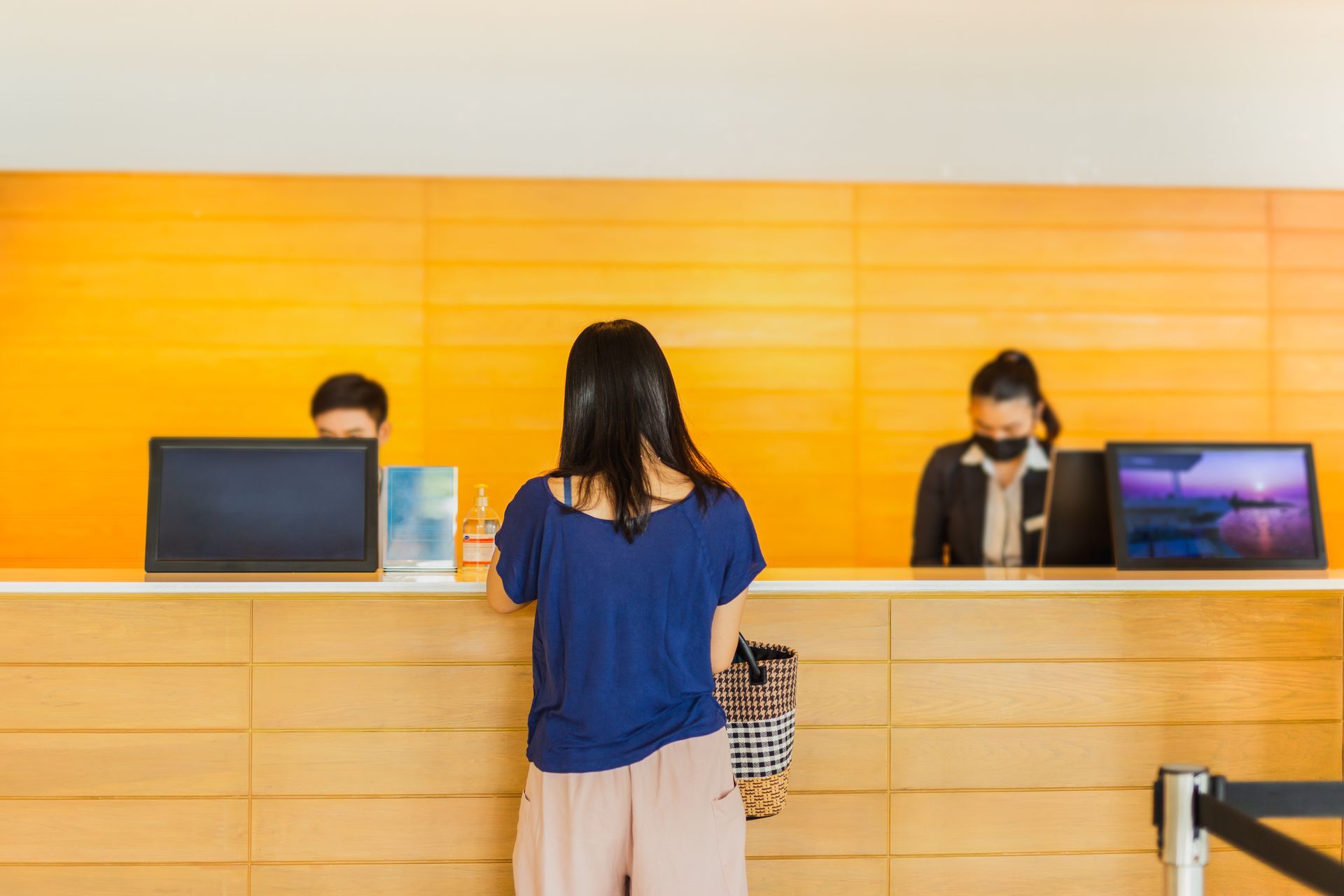 Woman at a bank desk being assisted by staff