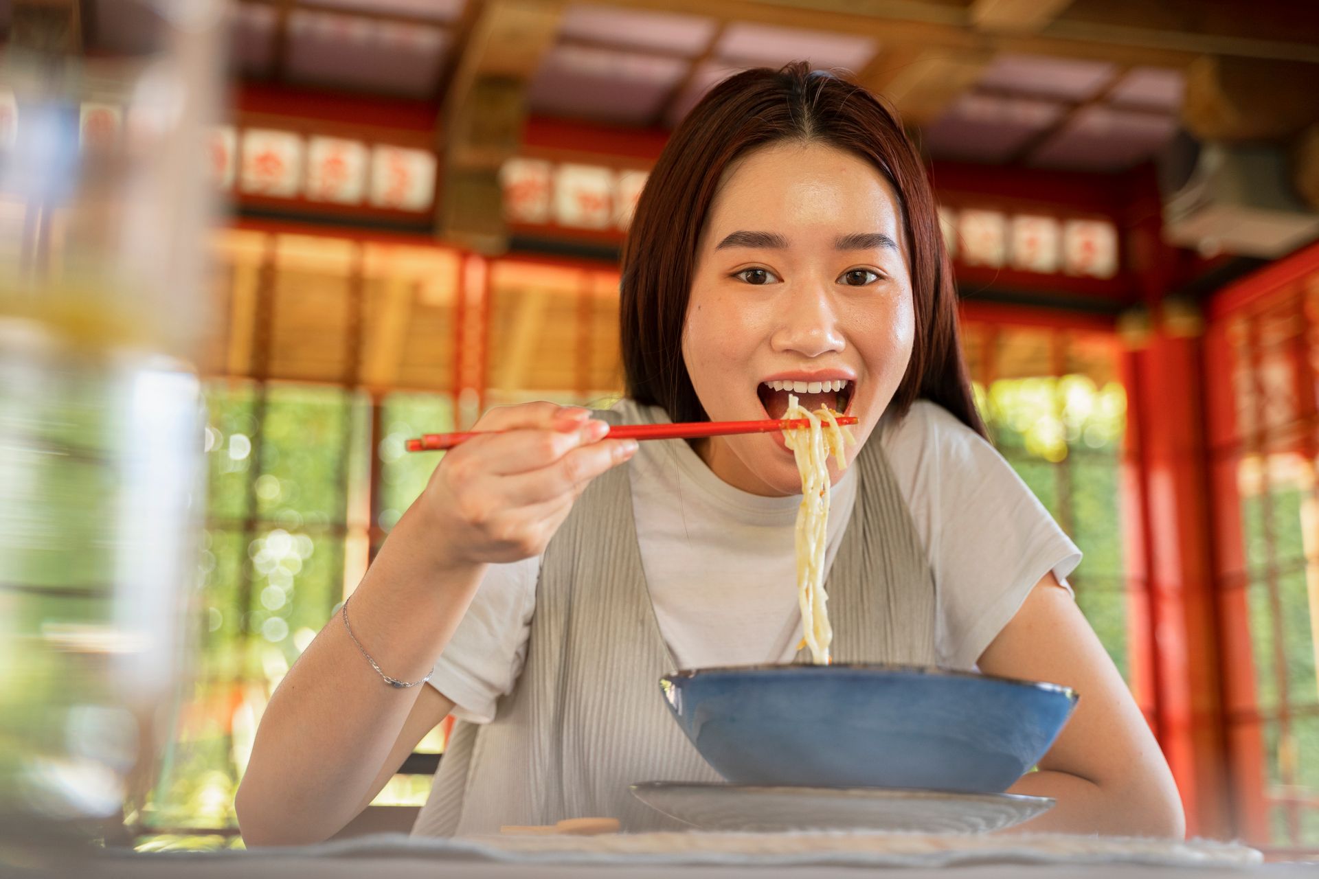 Young couple happily eating instant noodles together