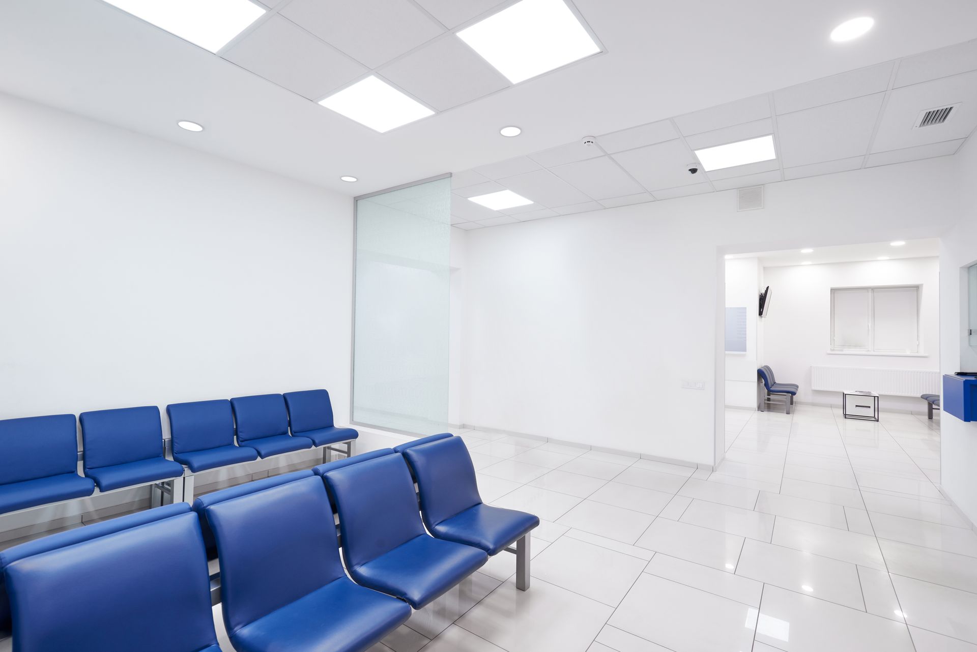 Two doctors reviewing a tablet together in a bright hospital