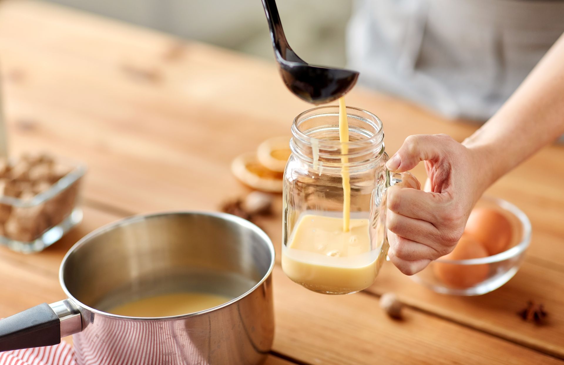 Alaska evaporated and condensed milk cans beside a baked leche flan