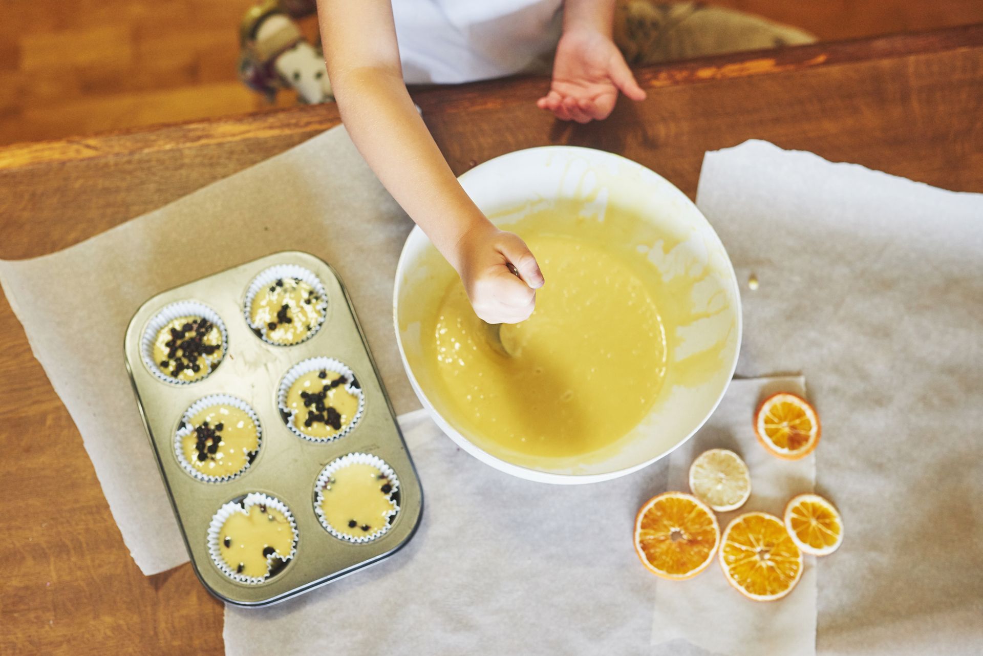 Alaska evaporated and condensed milk cans beside a baked leche flan