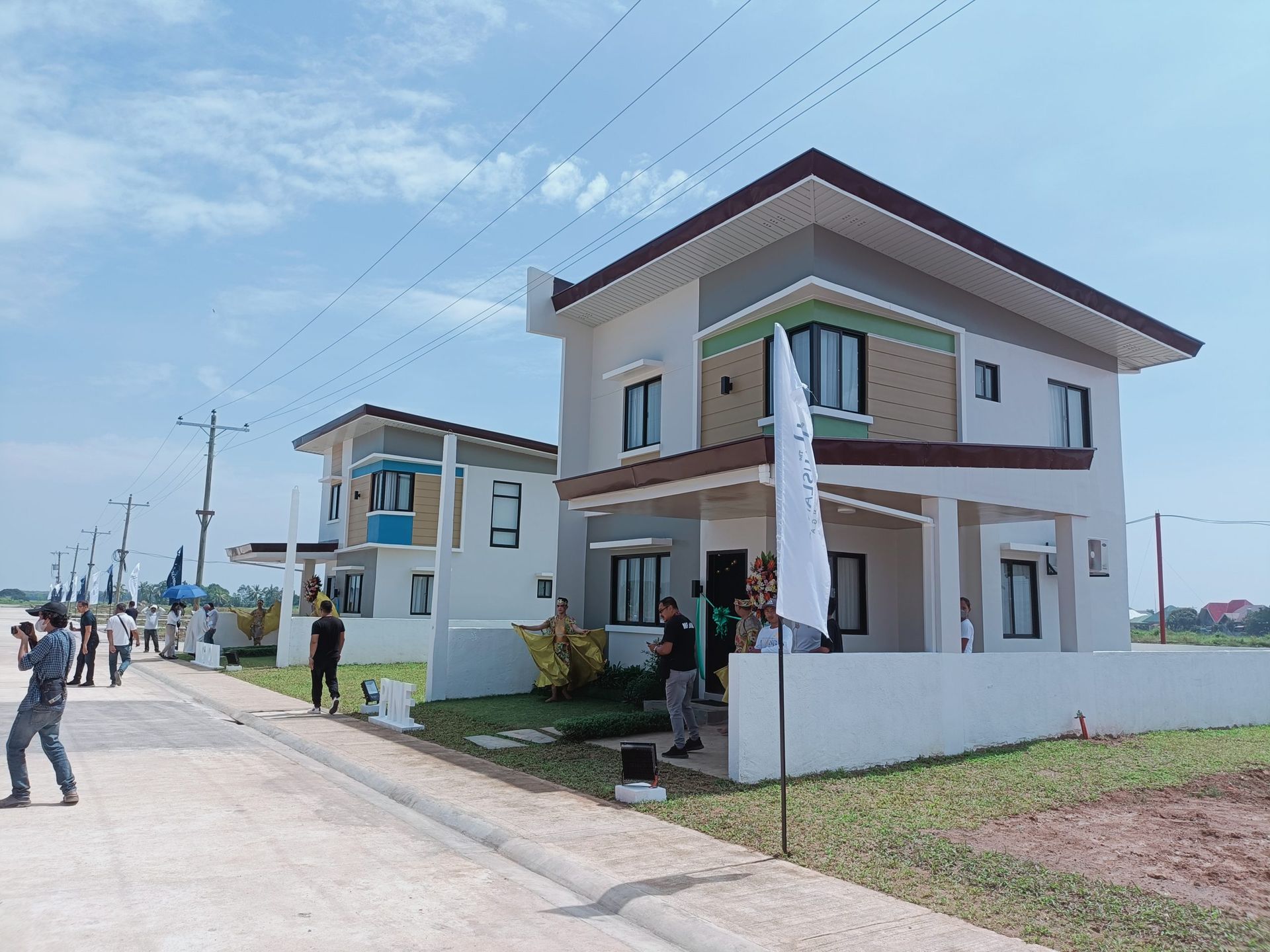 Two-story house in a new residential subdivision with people outside