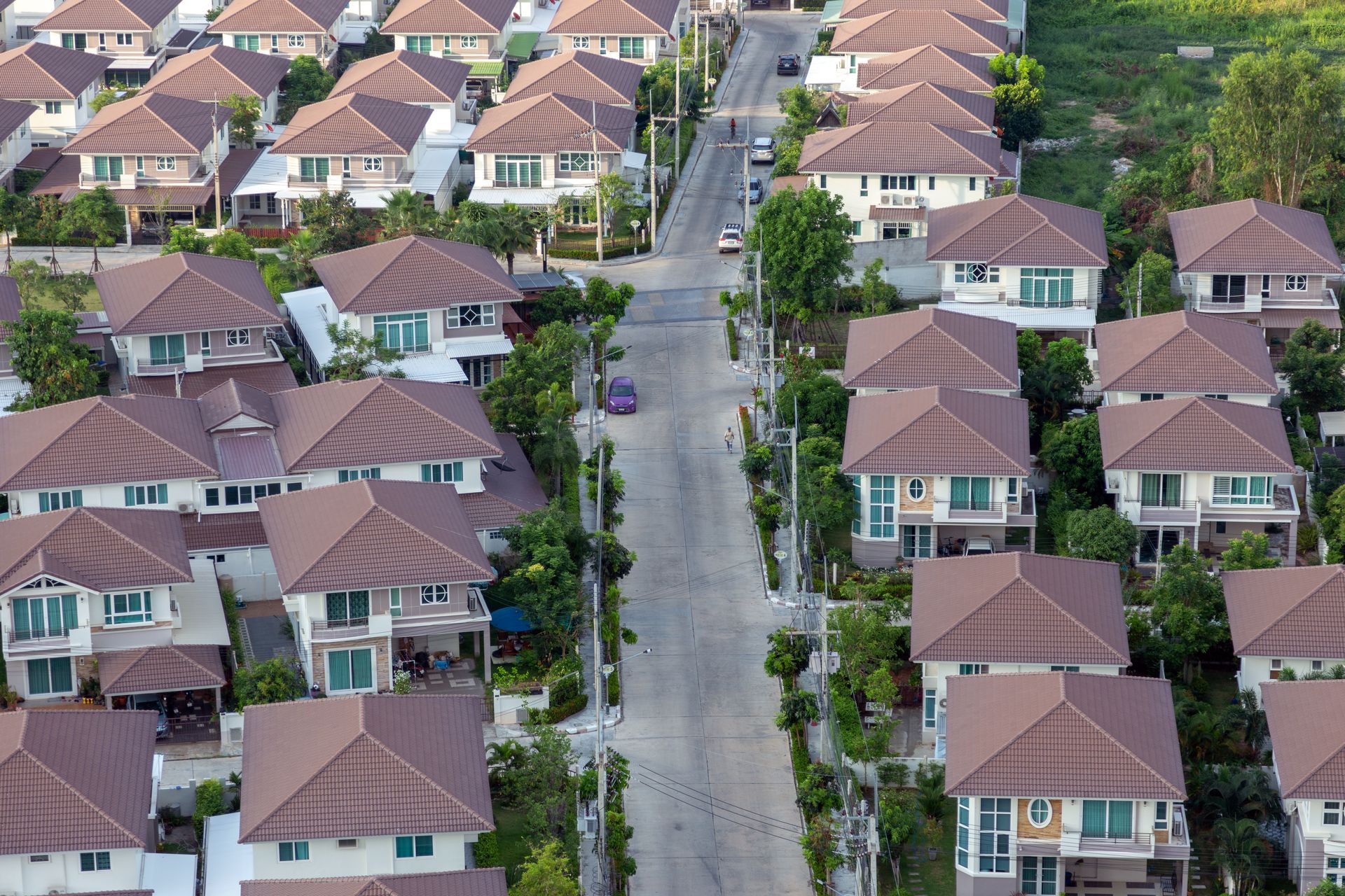 Two-story house in a new residential subdivision with people outside