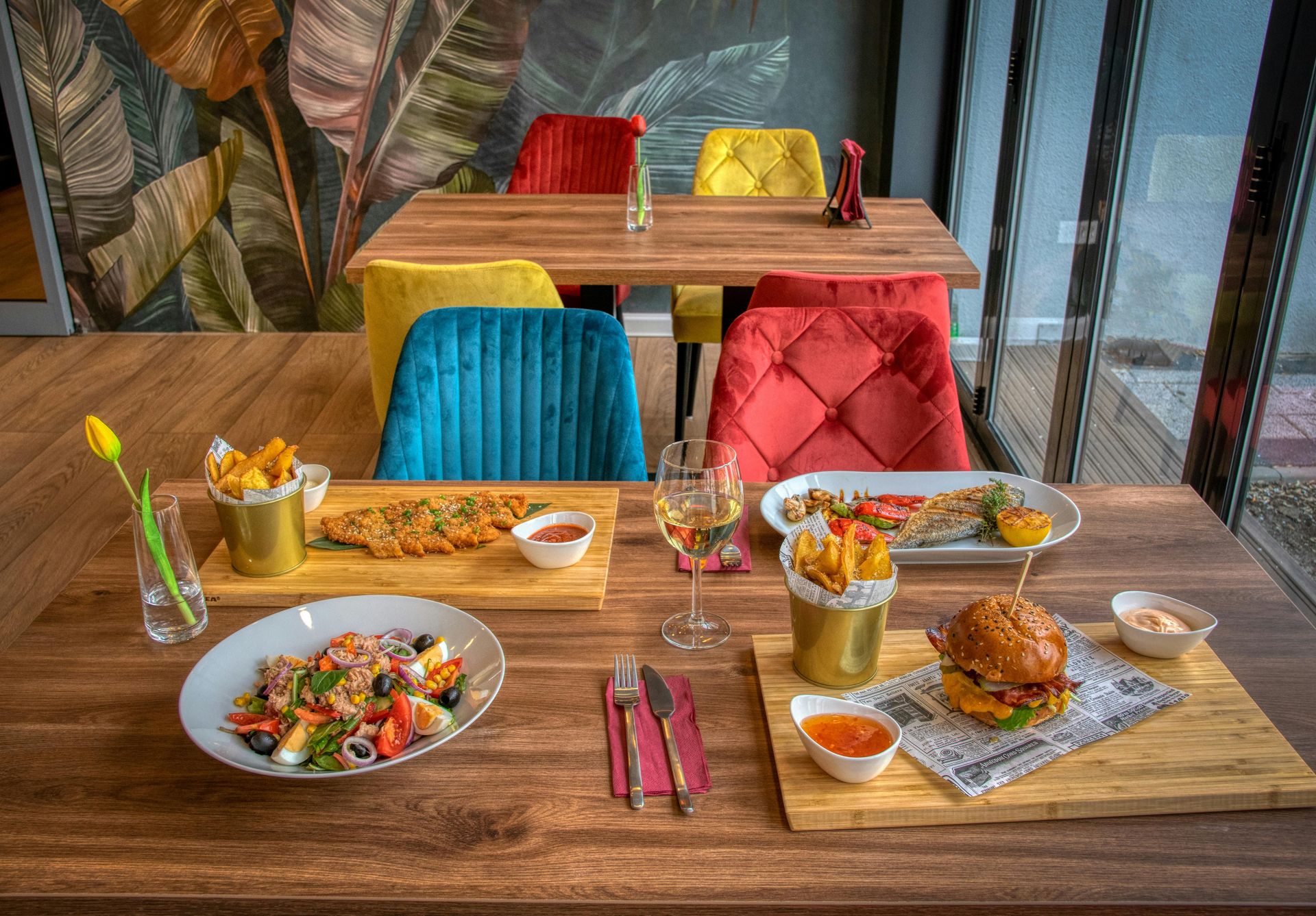 Cozy restaurant booth with blue seating and a koi wall mural