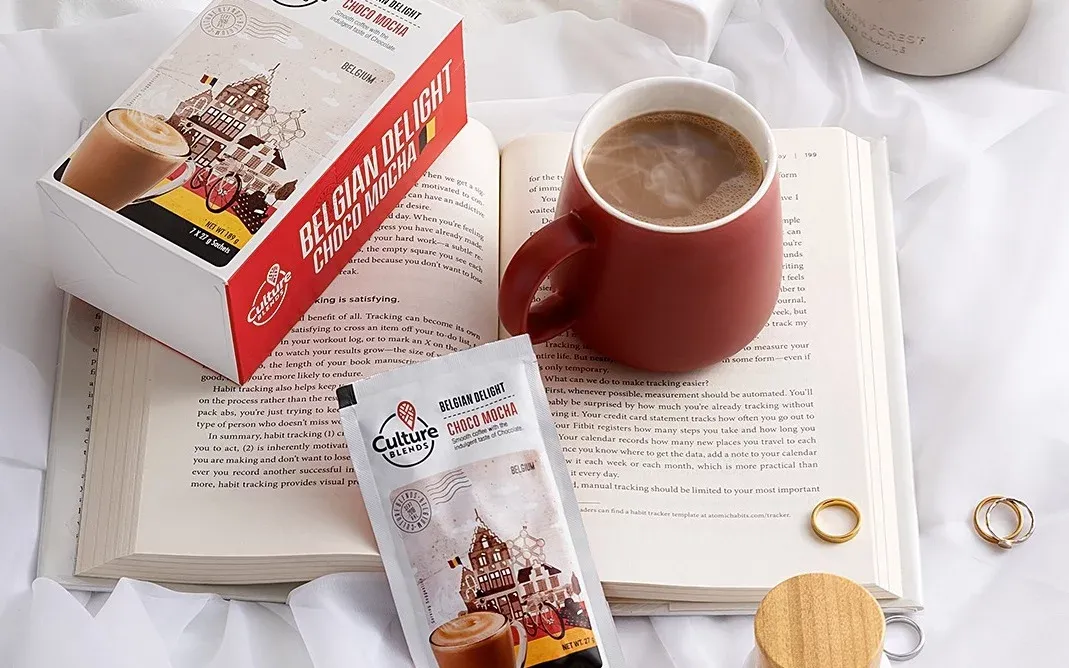 Display of Culture Brew coffee packs with a red bus and mug