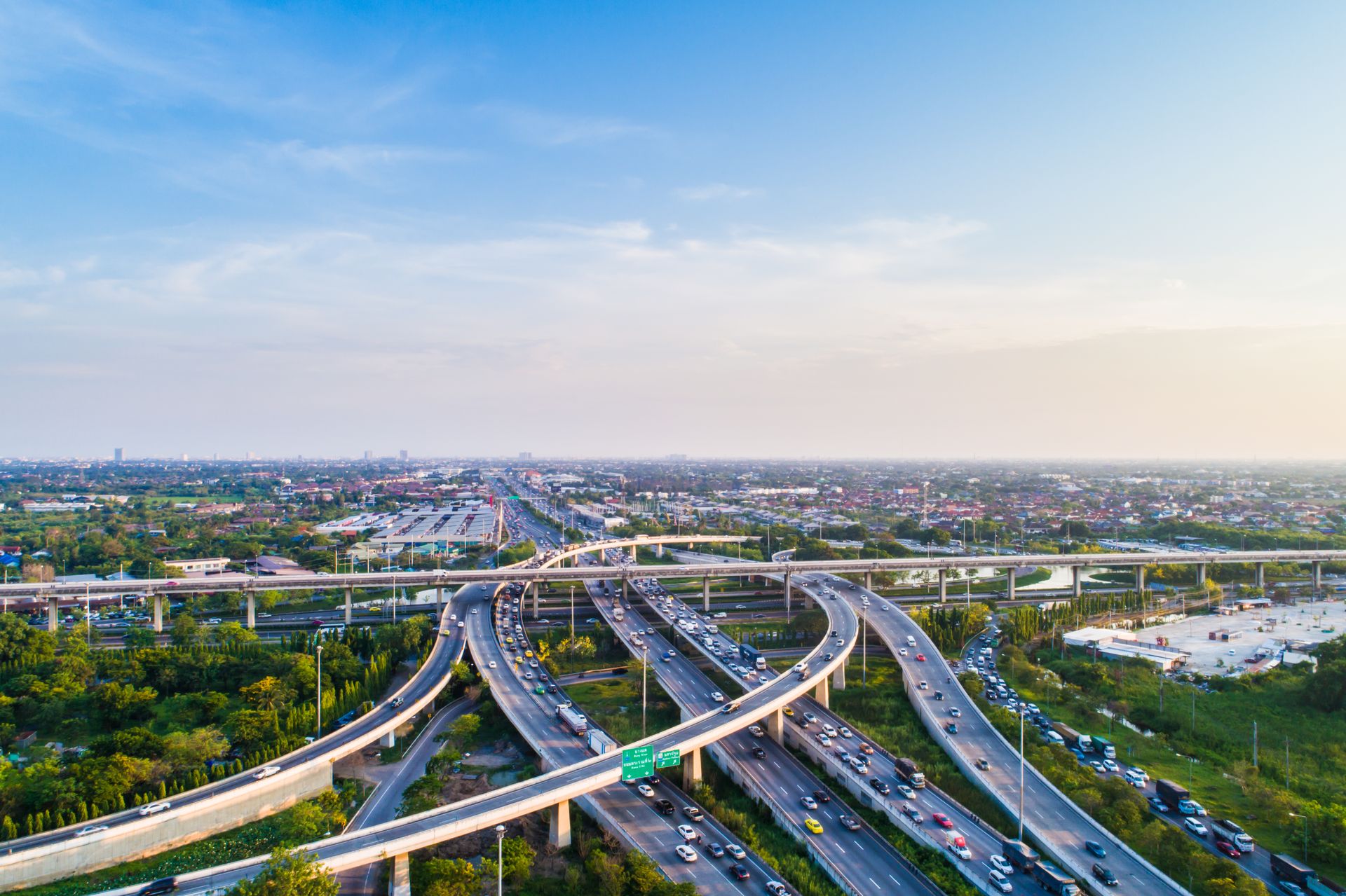 Aerial view of a multi-lane expressway toll plaza with traffic