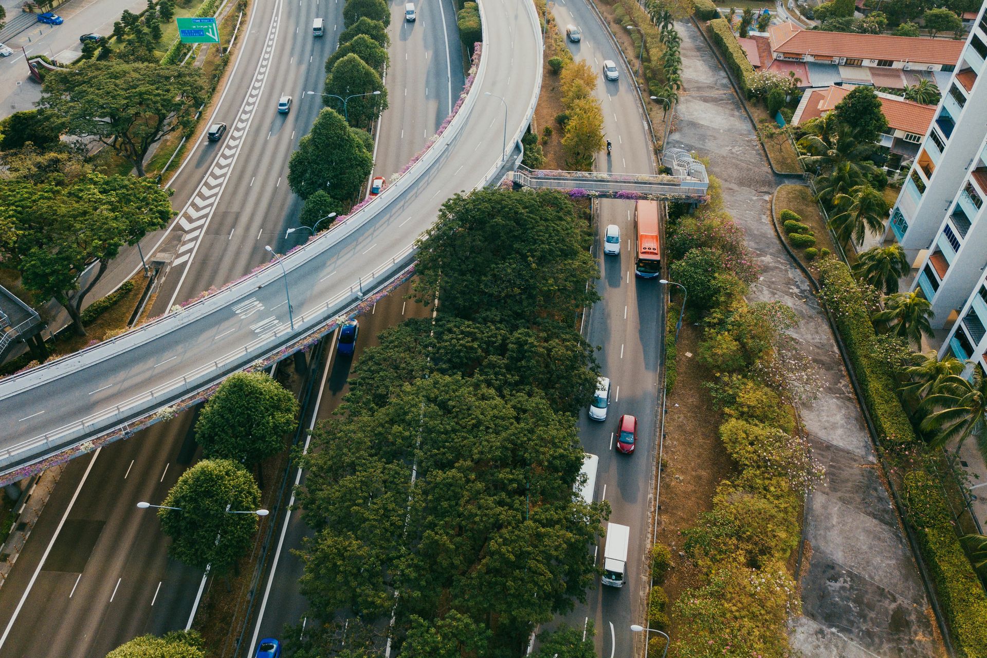 Aerial view of a multi-lane expressway toll plaza with traffic