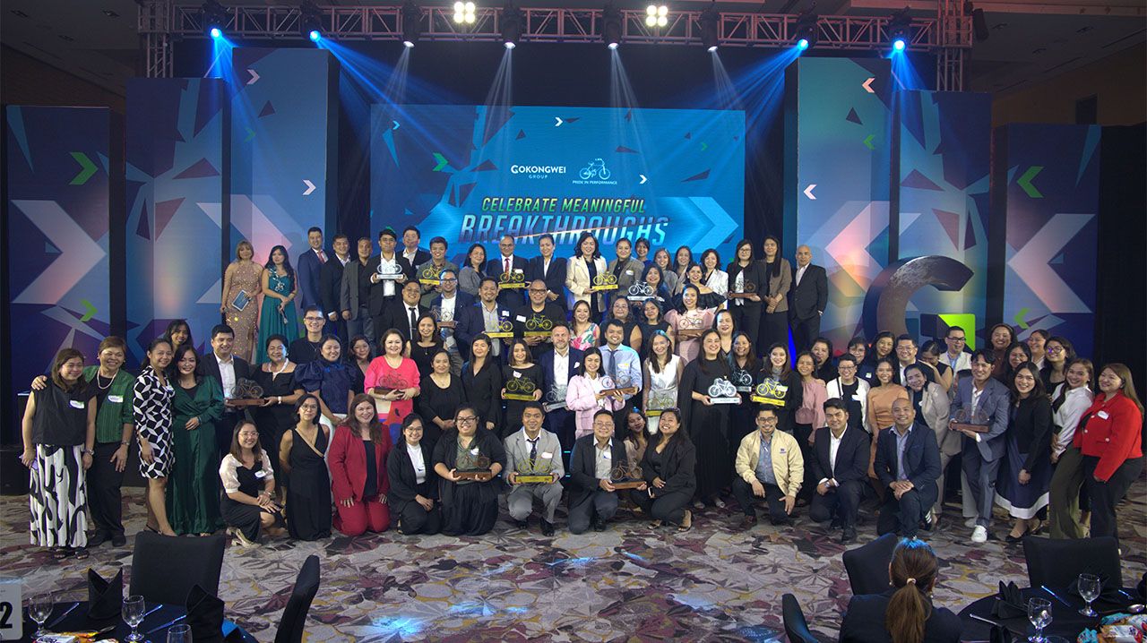 Gokongwei Group executives posing together on stage at an event