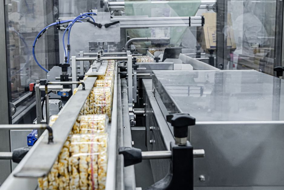 Automated packaging line moving products along a factory conveyor