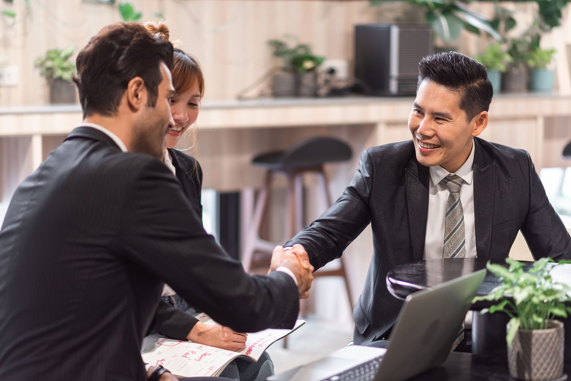 Executives in discussion around a glass conference table