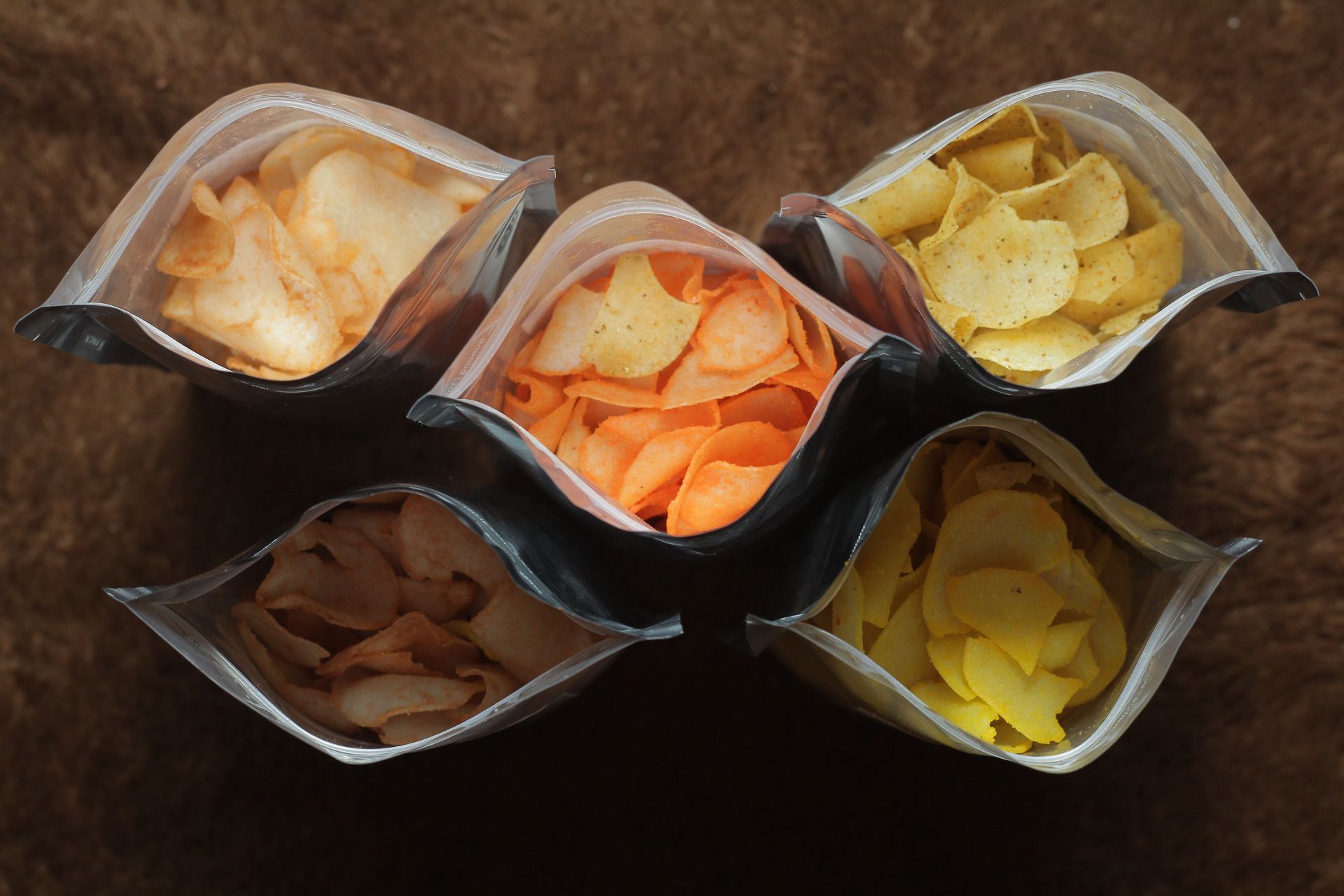 Fully stocked supermarket shelves of packaged snacks