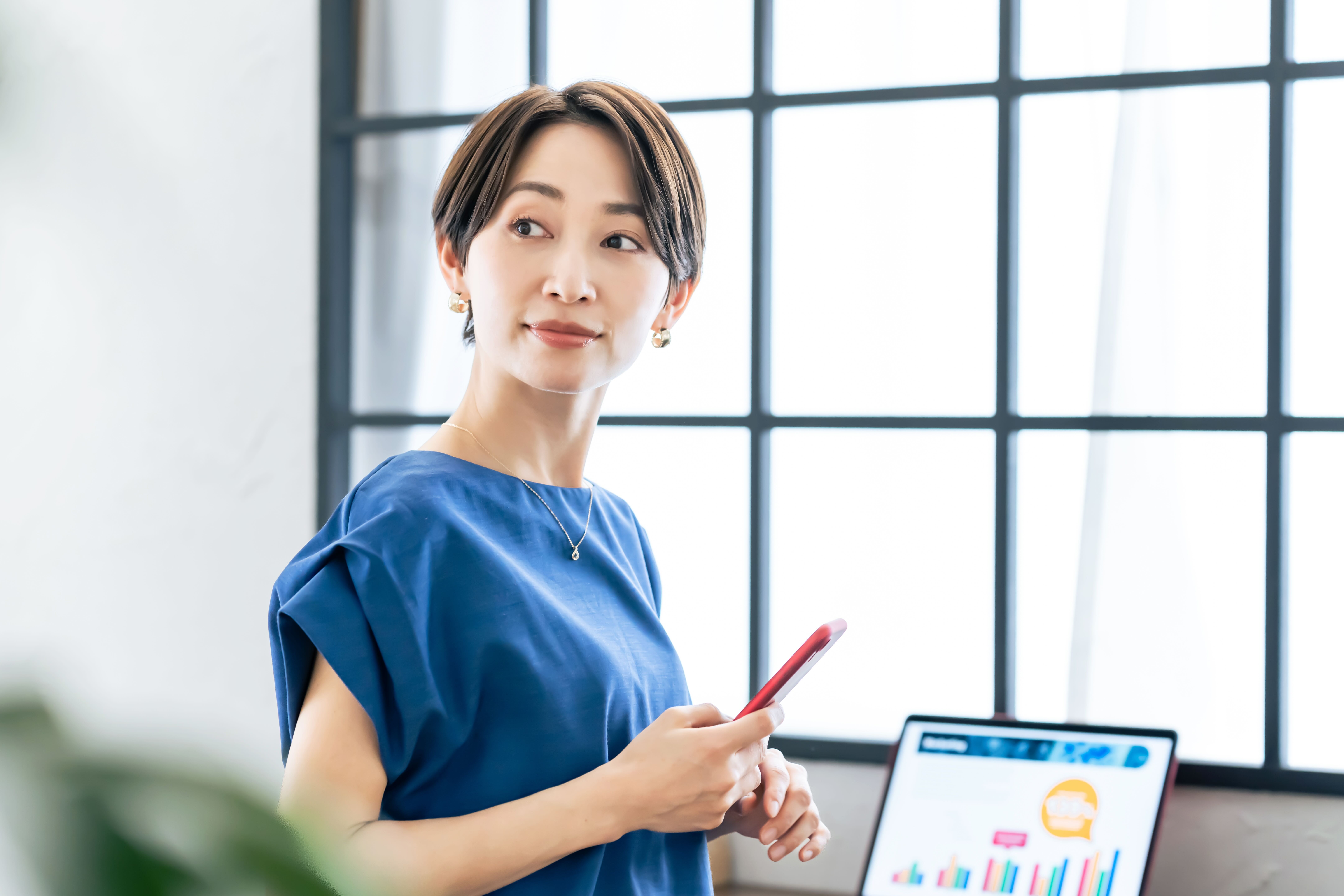 Woman holding a payment card and phone while shopping online