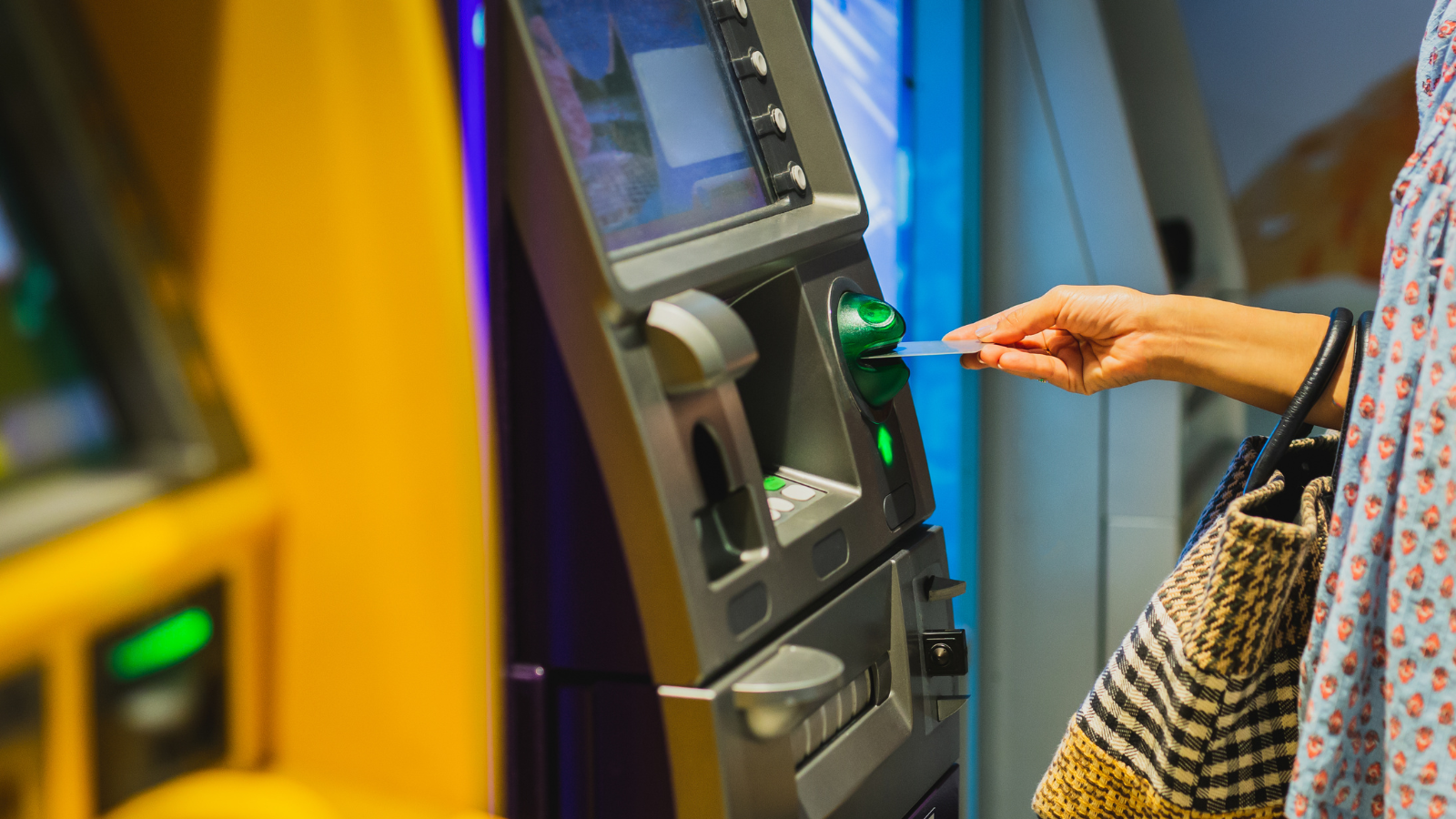 Woman at a bank desk being assisted by staff
